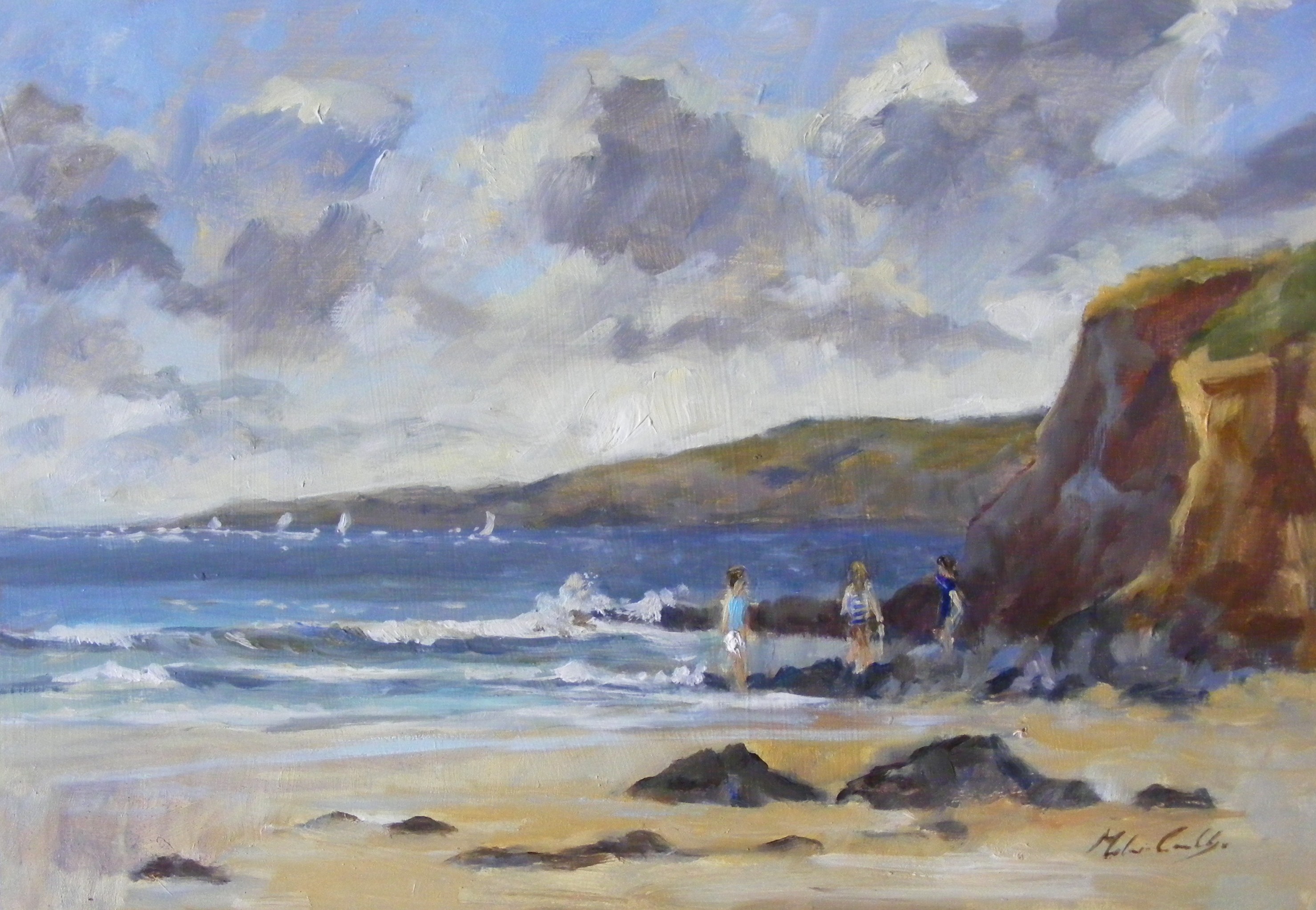 incoming surf breaking onto sand with  distant cliffs