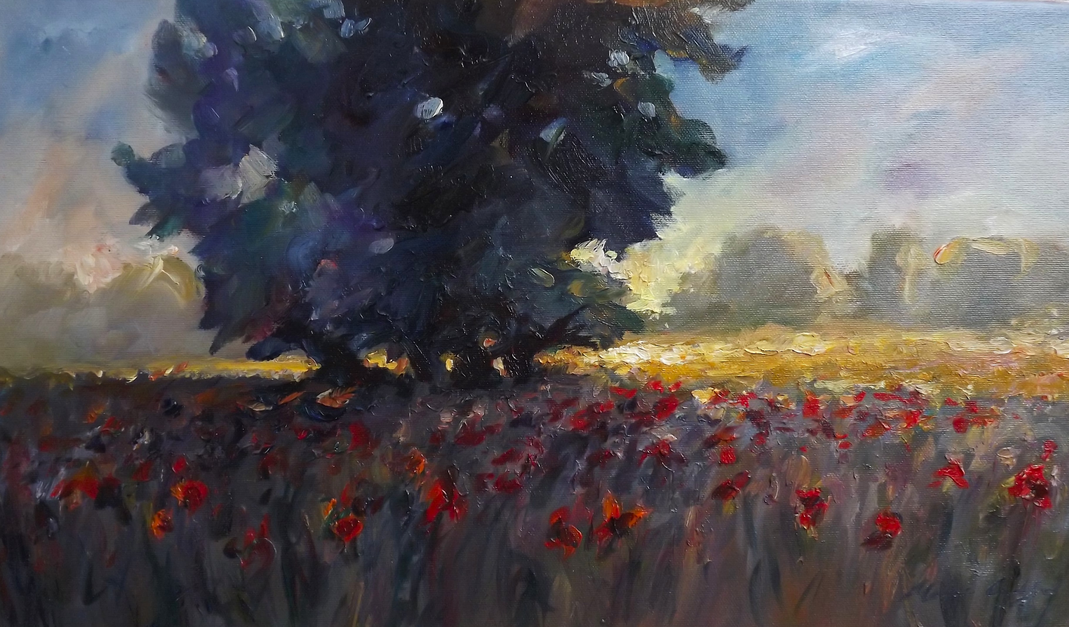 Large tree at dusk with backlighting and flowers in a meadow