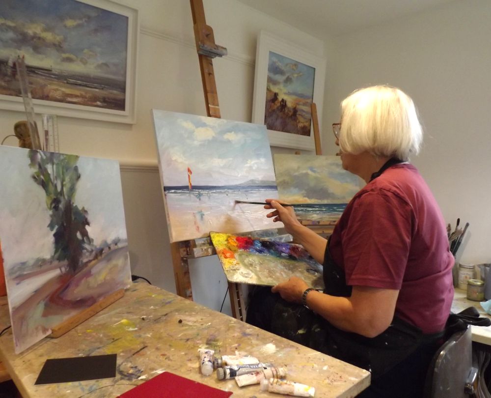 Melanie painting in her studio