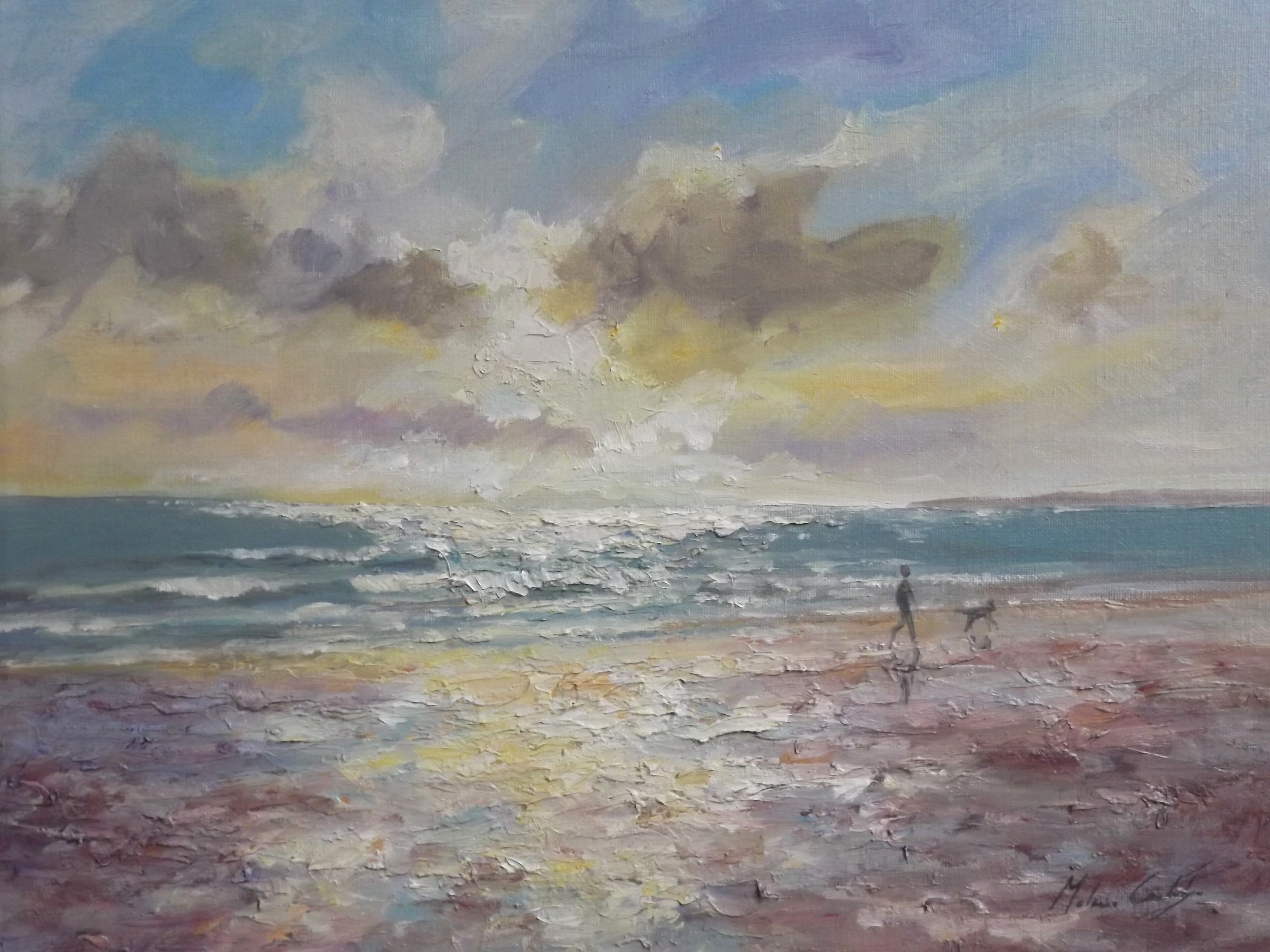 Figure and dog walking along the beach at West Wittering